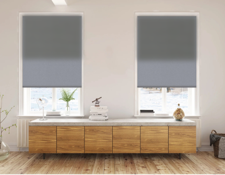 Double Roller Shades with grey blackout shades installed on to two windows